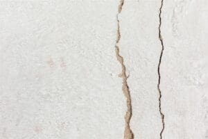 a crack in the side of a white wall